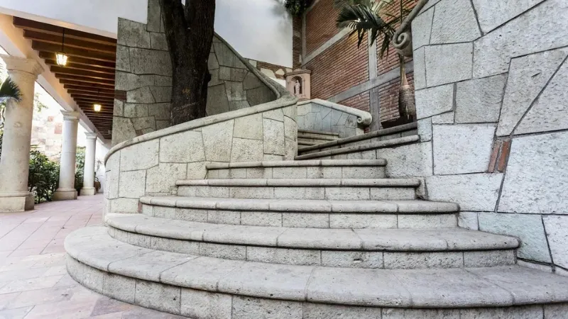 Stone staircase leading up to the upper levels of the NaNa Vida Hotel Oaxaca in Mexico