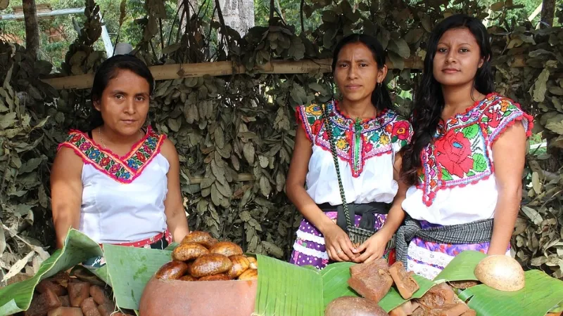 Women selling bread wearing traditional chatino blouses in Juquila, Oaxaca, Mexico